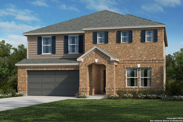 view of front of home with a garage and a front lawn