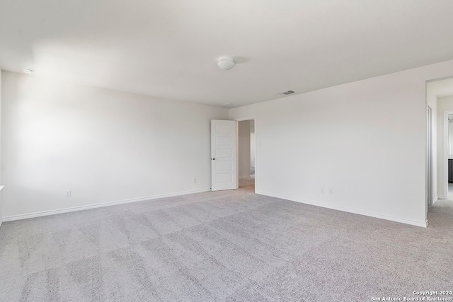 unfurnished room with light carpet