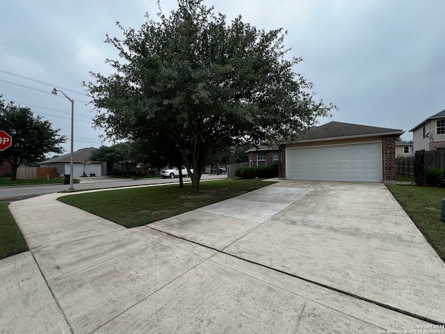 ranch-style house with a front yard and a garage