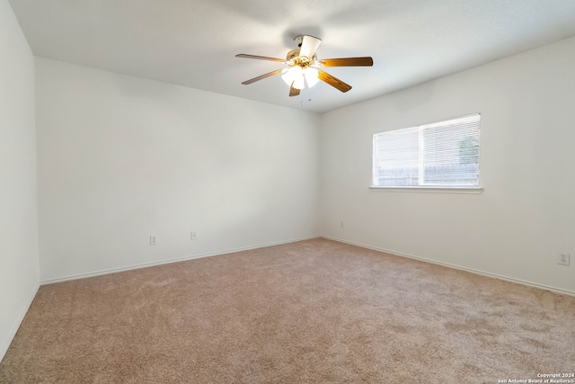 unfurnished room with ceiling fan and light colored carpet