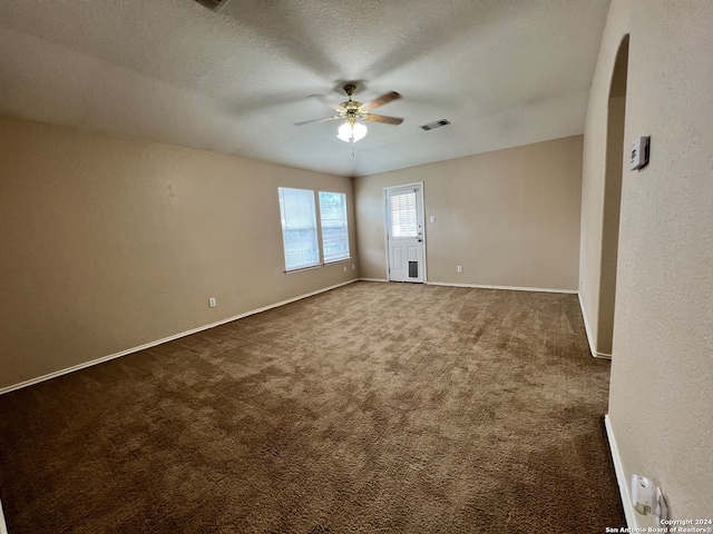 carpeted spare room with a textured ceiling and ceiling fan