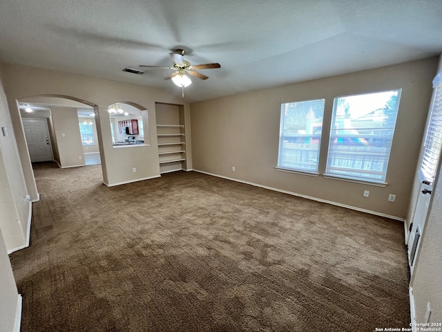 carpeted empty room featuring a textured ceiling and ceiling fan