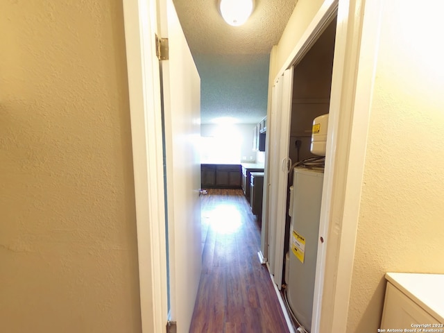 hallway with dark hardwood / wood-style floors and a textured ceiling