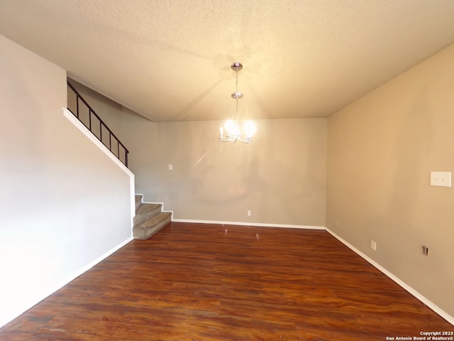 unfurnished room with dark hardwood / wood-style floors and a textured ceiling