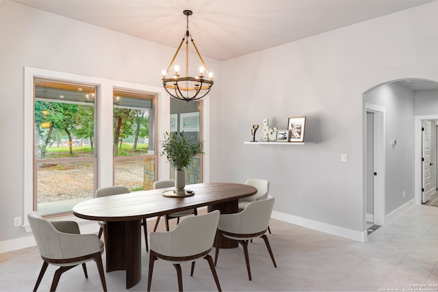 dining room featuring light tile floors and an inviting chandelier