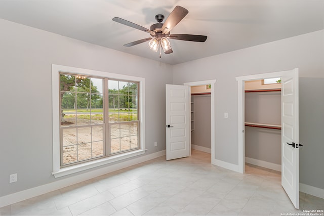 unfurnished bedroom with ceiling fan and light tile floors