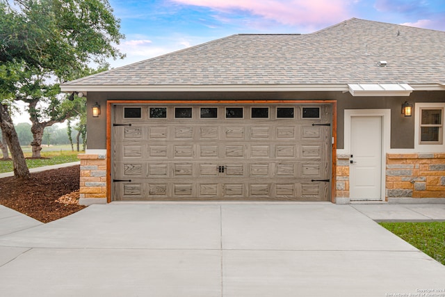 view of garage at dusk