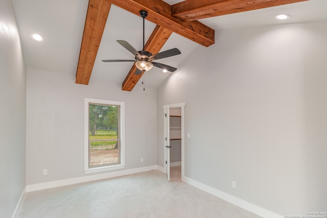 spare room featuring ceiling fan and vaulted ceiling with beams