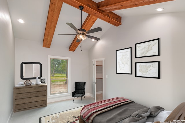 tiled bedroom with lofted ceiling with beams, a walk in closet, and ceiling fan