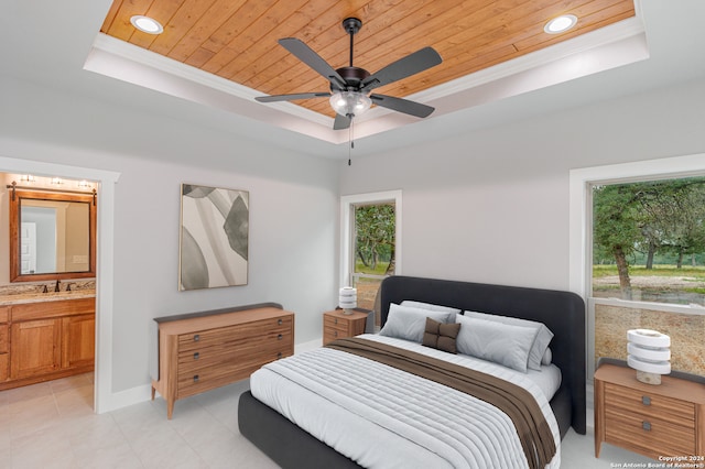 tiled bedroom featuring ensuite bath, wooden ceiling, ceiling fan, and a tray ceiling