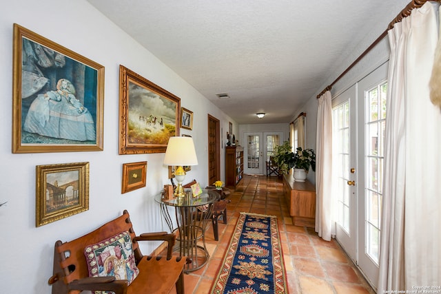 interior space featuring french doors and a textured ceiling