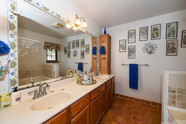 bathroom featuring a textured ceiling, tile floors, and double vanity