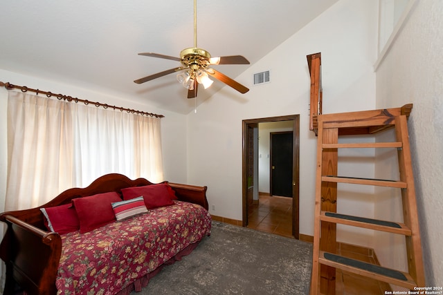 tiled bedroom with high vaulted ceiling and ceiling fan