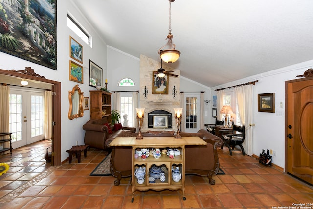 living room featuring high vaulted ceiling, ceiling fan, crown molding, a large fireplace, and tile floors