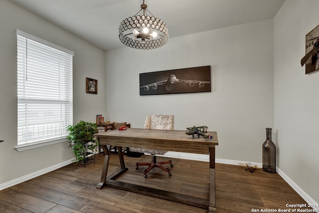 office with an inviting chandelier and dark hardwood / wood-style floors