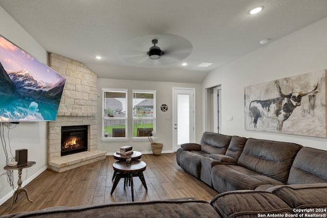 living room with hardwood / wood-style flooring, a fireplace, lofted ceiling, and ceiling fan