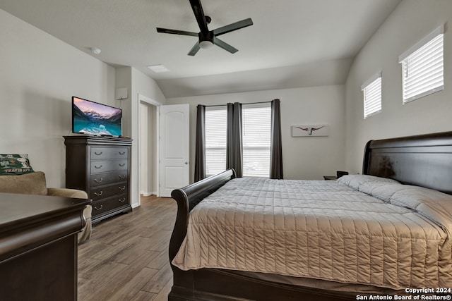 bedroom featuring lofted ceiling, wood-type flooring, and ceiling fan