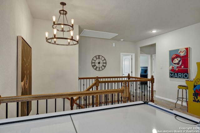 corridor with an inviting chandelier