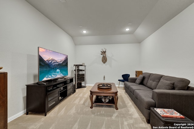 living room featuring vaulted ceiling and light colored carpet