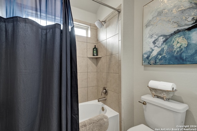 bathroom featuring toilet and shower / bath combo with shower curtain