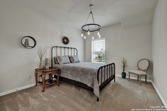 bedroom with carpet floors and an inviting chandelier