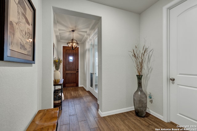 entryway with dark hardwood / wood-style floors and an inviting chandelier