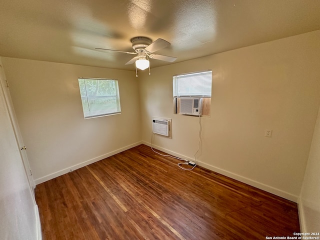 unfurnished room with a wealth of natural light, wood-type flooring, and ceiling fan