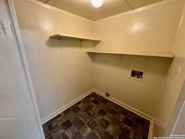 laundry room with dark tile flooring and hookup for a washing machine