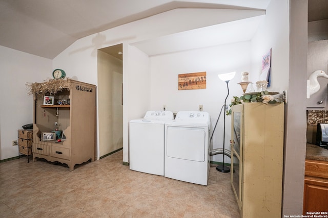 washroom with light tile flooring and washer and clothes dryer