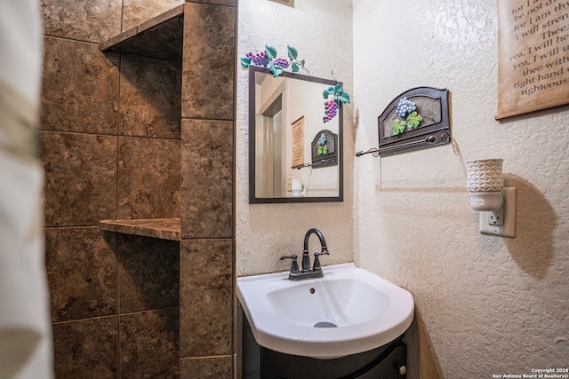 bathroom featuring vanity with extensive cabinet space