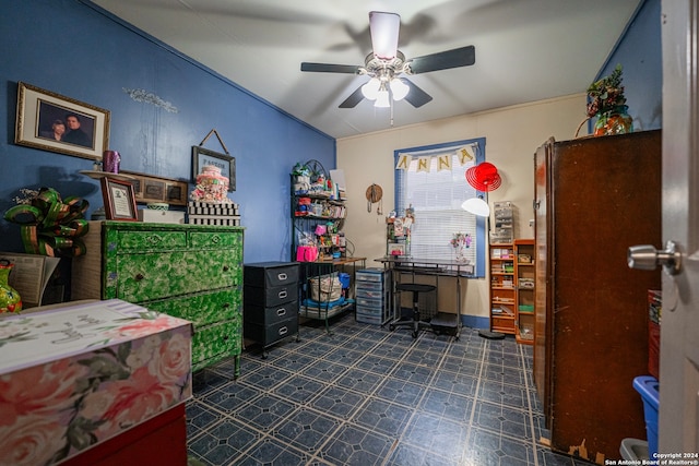 office area with dark tile flooring and ceiling fan