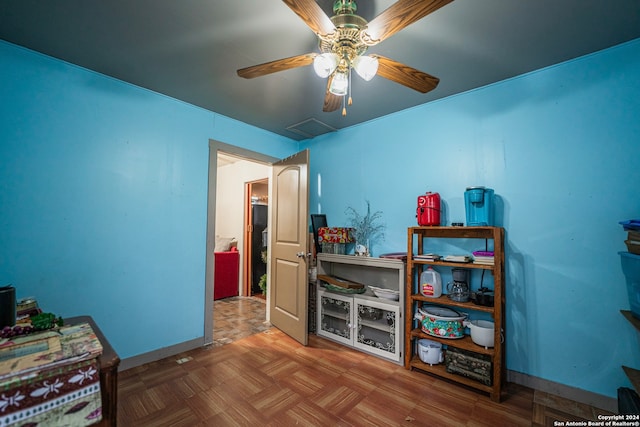 misc room featuring ceiling fan and parquet floors