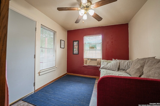 unfurnished living room with a wealth of natural light and ceiling fan