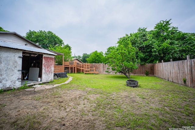 view of yard with an outdoor fire pit and an outdoor structure