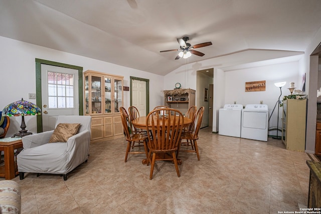 tiled dining space with vaulted ceiling, ceiling fan, and washer and dryer