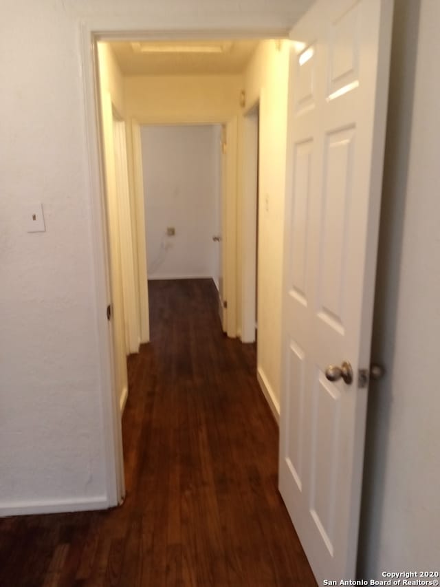 corridor with dark wood-type flooring