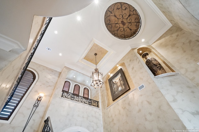 stairs with a towering ceiling and ornamental molding