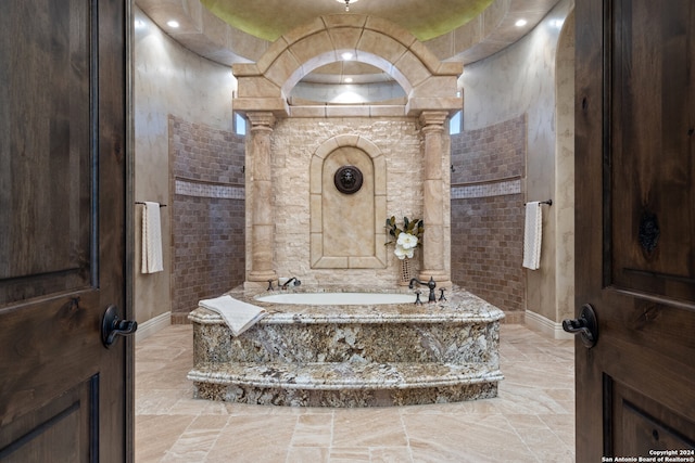 bathroom featuring independent shower and bath, a raised ceiling, and tile floors