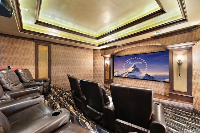 home theater room with ornamental molding, ornate columns, and a raised ceiling