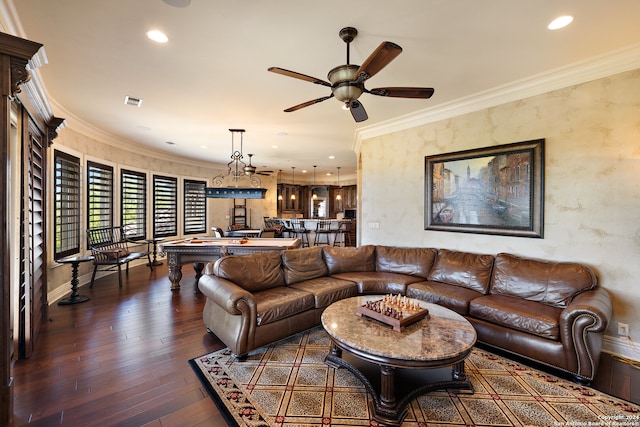 living room with ornamental molding, ceiling fan, and dark wood-type flooring