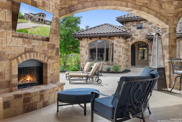 view of patio / terrace with an outdoor stone fireplace