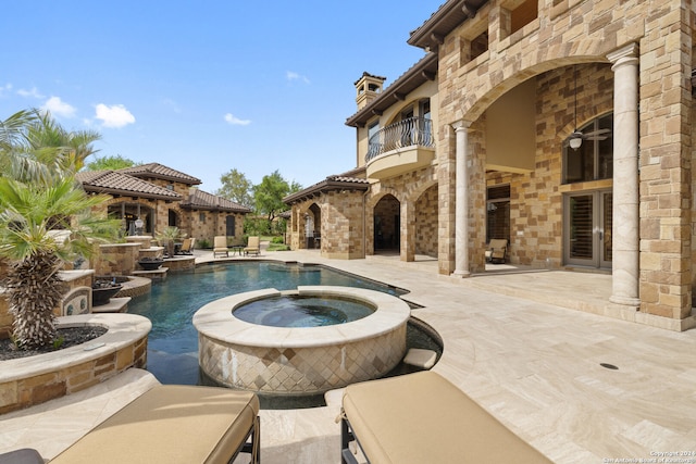 view of swimming pool with a patio and an in ground hot tub