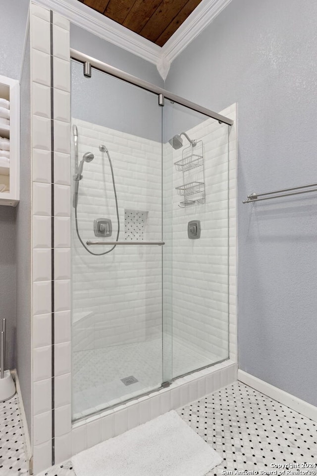 bathroom with a shower with shower door, wooden ceiling, ornamental molding, and tile floors