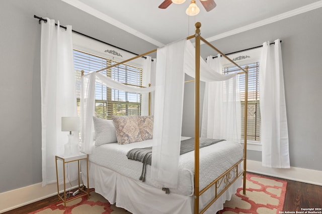 bedroom featuring hardwood / wood-style floors, ceiling fan, and crown molding