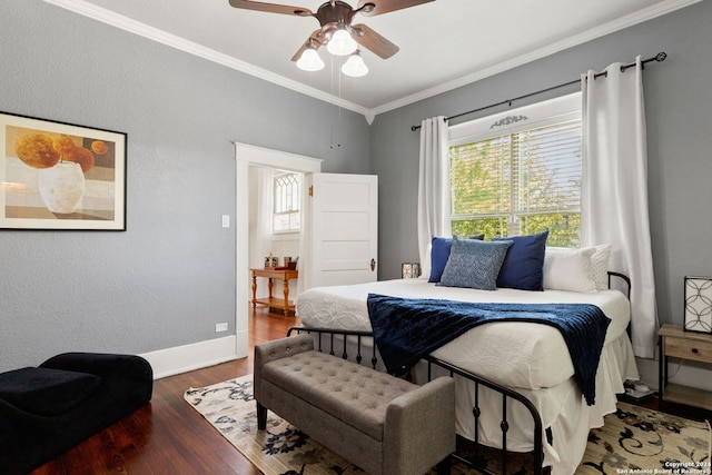 bedroom featuring hardwood / wood-style floors, ornamental molding, and ceiling fan