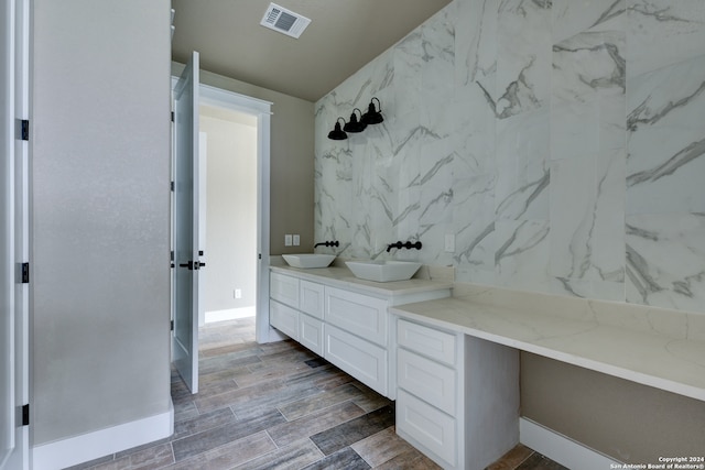 bathroom featuring tile walls and vanity