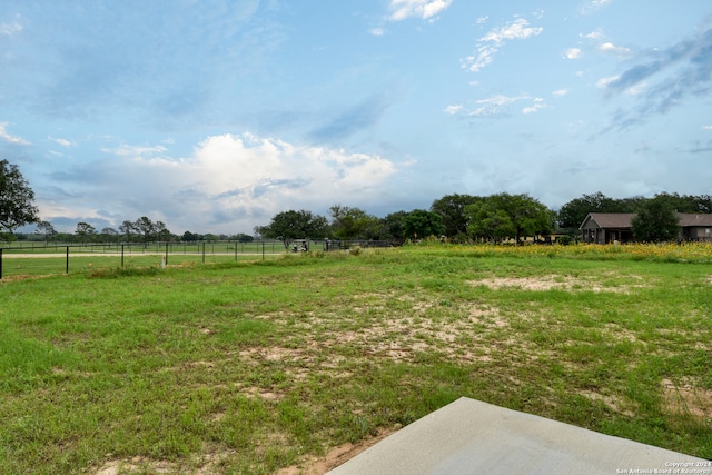 view of yard with a rural view