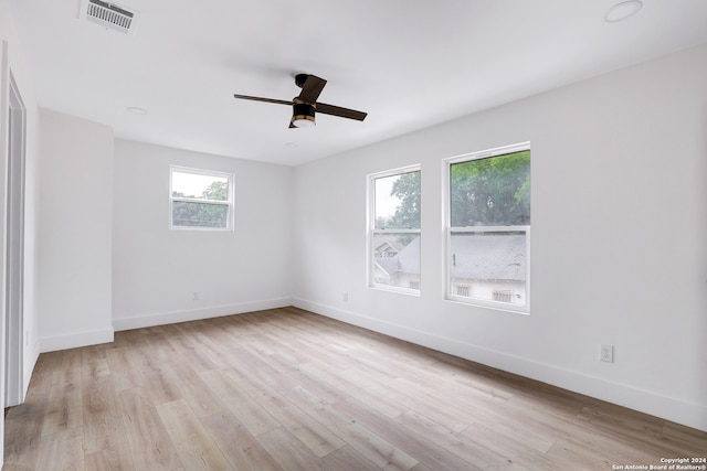 unfurnished room with ceiling fan and light wood-type flooring