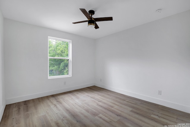 unfurnished room with ceiling fan and light wood-type flooring