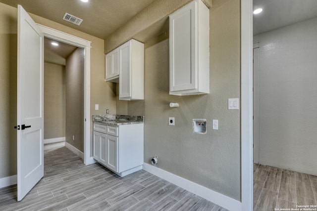 kitchen with light stone counters and white cabinetry